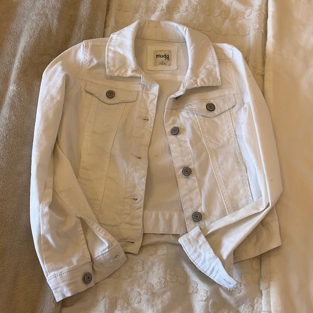 This is a mud girls white jean jacket